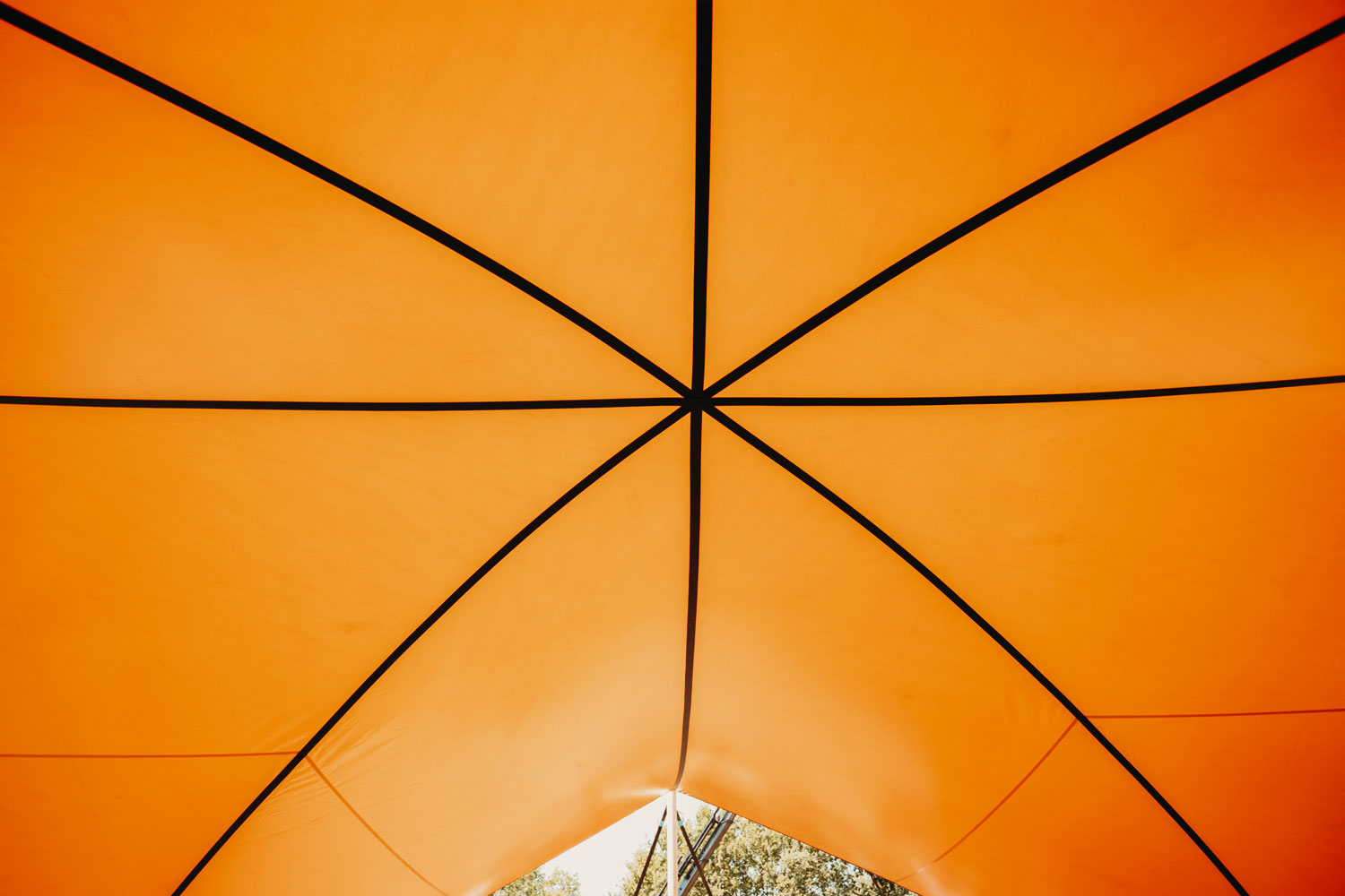 Under our HEXA festival shelter in orange