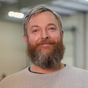 Qtents employee with a big beard and a smile