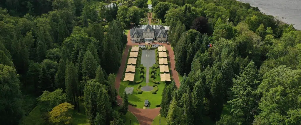 drone shots of Qtents stretch tent next to water at Aurora event sweden with luxury cars