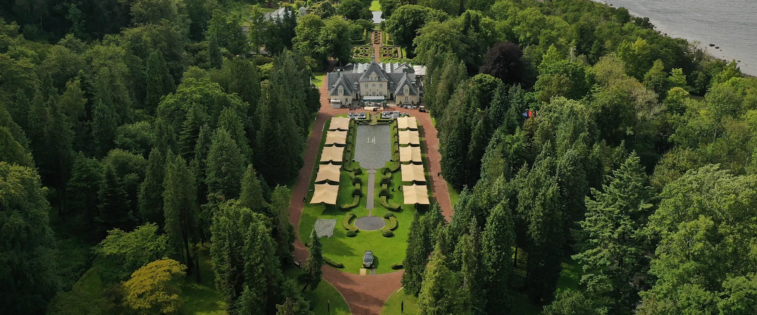 drone shots of Qtents stretch tent next to water at Aurora event sweden with luxury cars